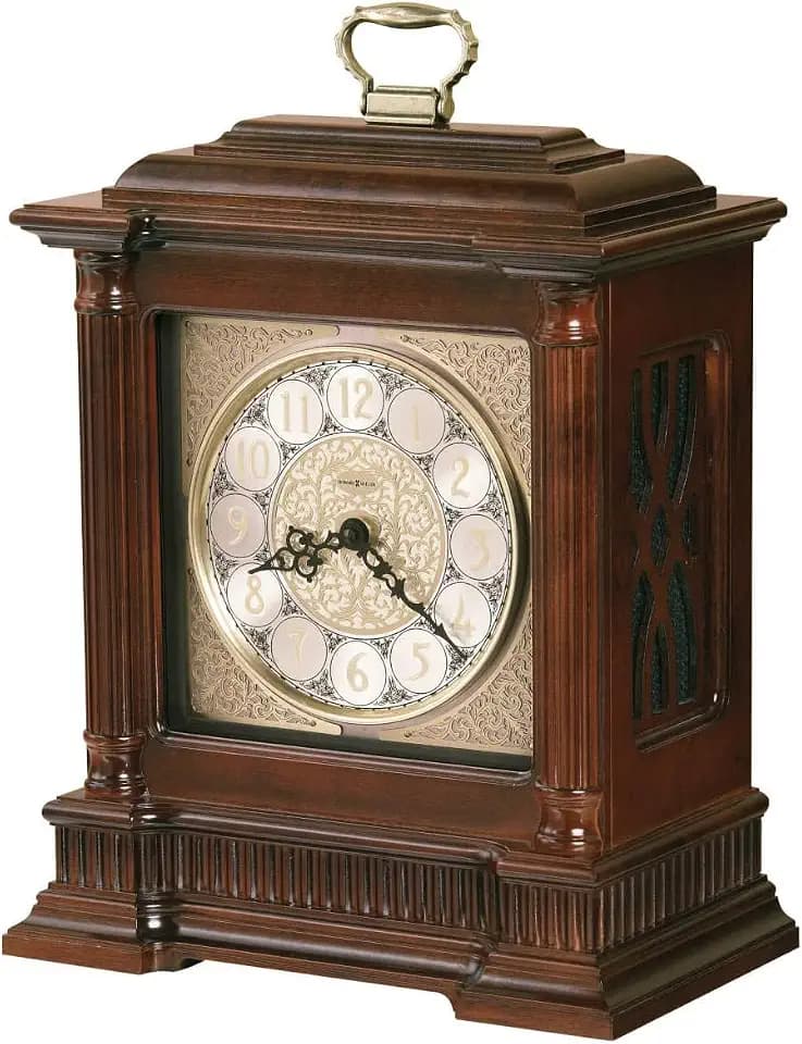 Howard Miller Orleans Mantel Clocks II, Wood Finish Clock Analog Dial with Arabic Numerals | Dual-Chime Movement Oval Shape Table Clock with Wooden Base for Living Room, Office & Home Decor